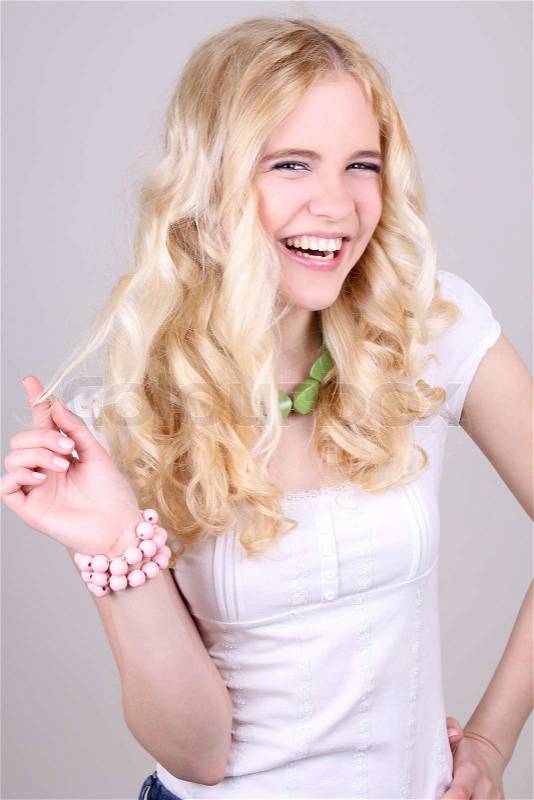 Funny blonde girl in studio, stock photo
