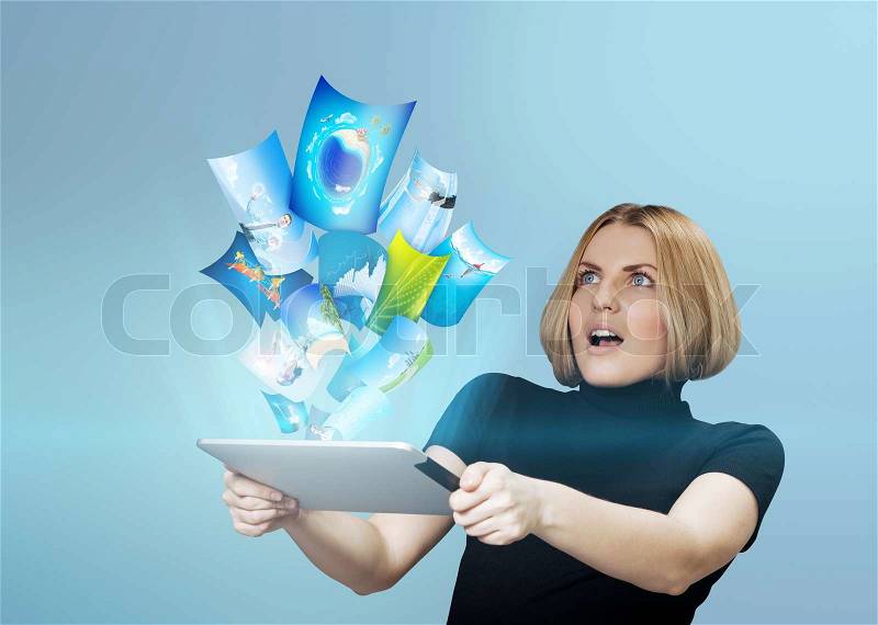 Young girl amazed with streaming content from touch pad device. Future technologies collection, stock photo