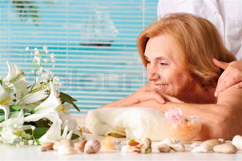 Beautiful Caucasian elderly woman at a reception, stock photo