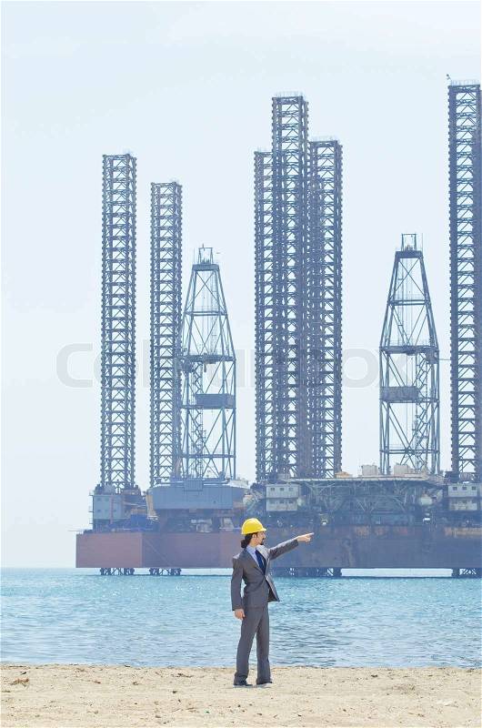 Oil engineer on sea side beach, stock photo