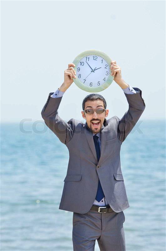 Man with clock on seaside, stock photo