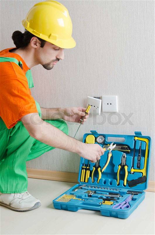 Electrician repairman working in the house, stock photo