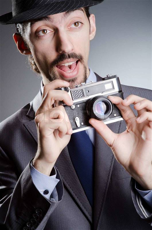 Photographer man with vintage camera, stock photo