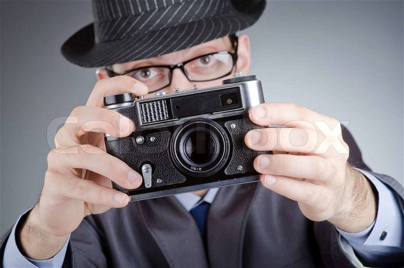 Photographer man with vintage camera, stock photo