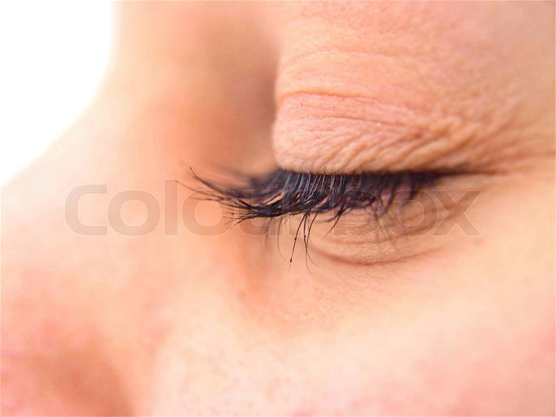 Female eye closeup of lashes on closed eye, stock photo