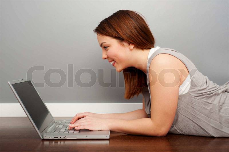 Pretty smiley woman with laptop, stock photo