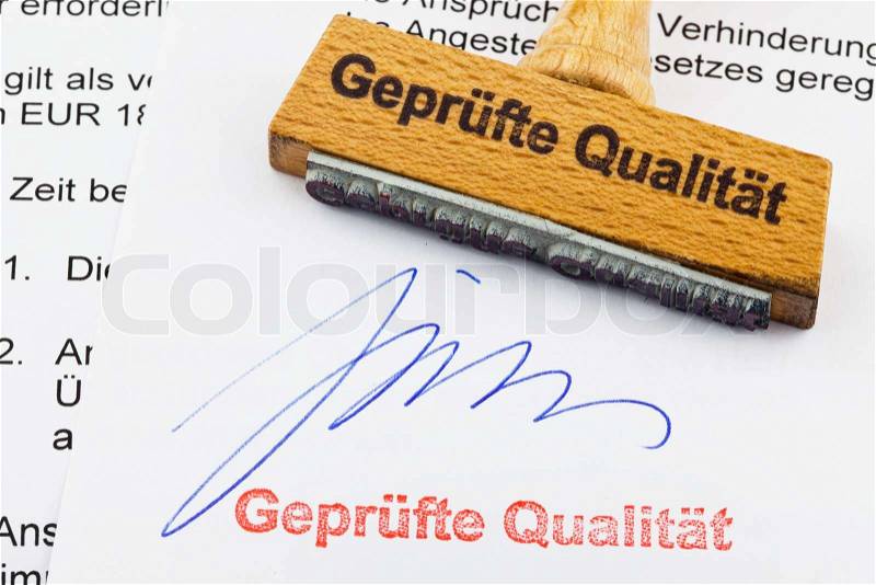 Wood stamp on the document: proven quality, stock photo