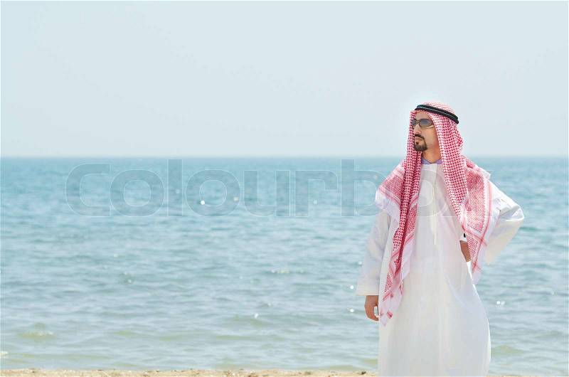 Arab on seaside in traditional clothing, stock photo
