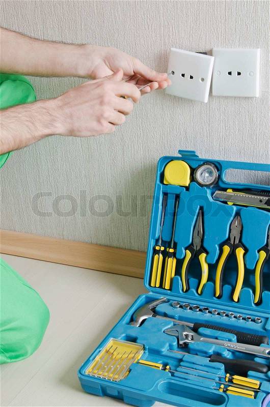 Electrician repairman working in the house, stock photo