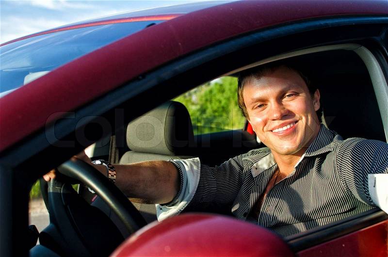 Portrait of a handsome man inside the car, stock photo