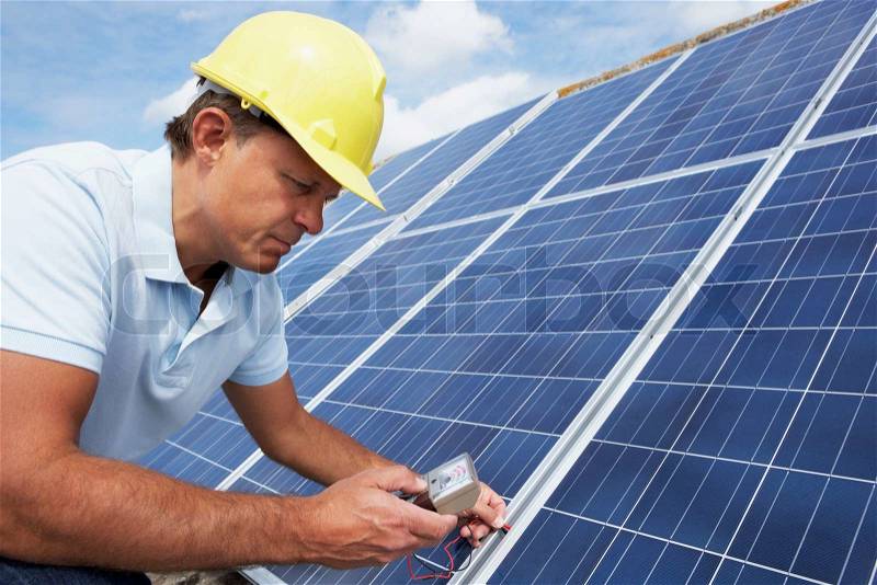 Man installing solar panels, stock photo