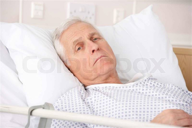 Senior man ill in hospital bed, stock photo