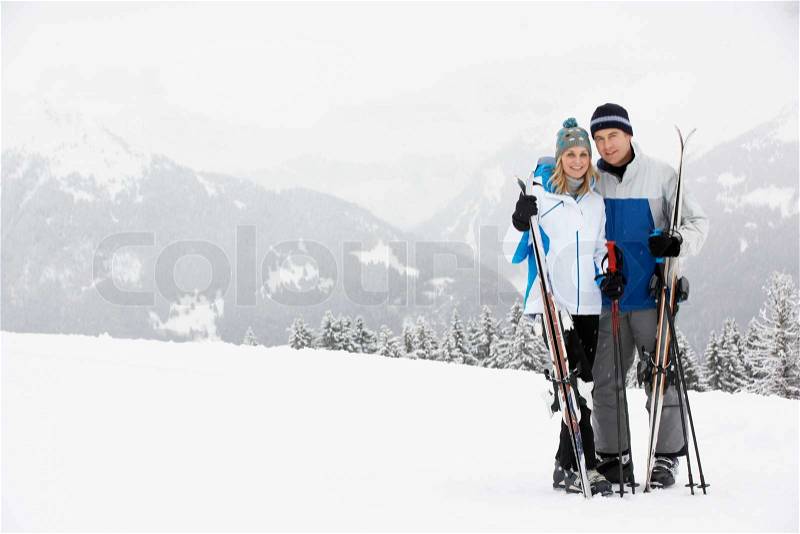 Middle Aged Couple On Ski Holiday In Mountains, stock photo