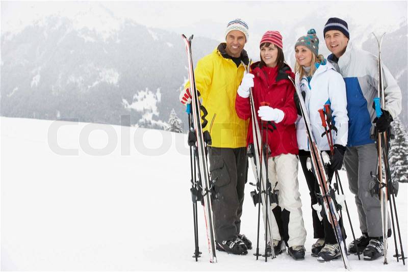 Group Of Middle Aged Couples On Ski Holiday In Mountains, stock photo