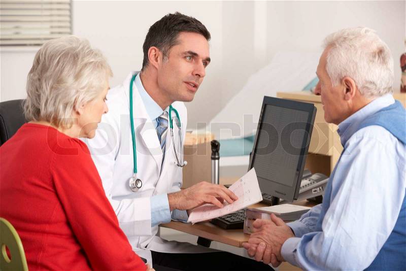 American doctor talking to senior couple in surgery, stock photo