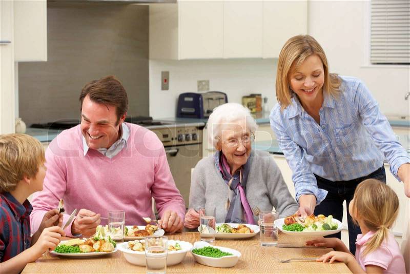 Multi-generation family sharing meal together, stock photo