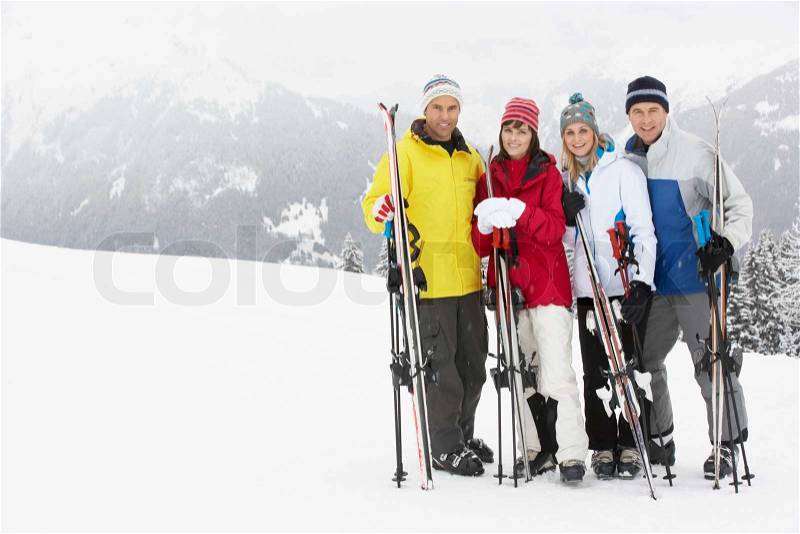 Group Of Middle Aged Couples On Ski Holiday In Mountains, stock photo