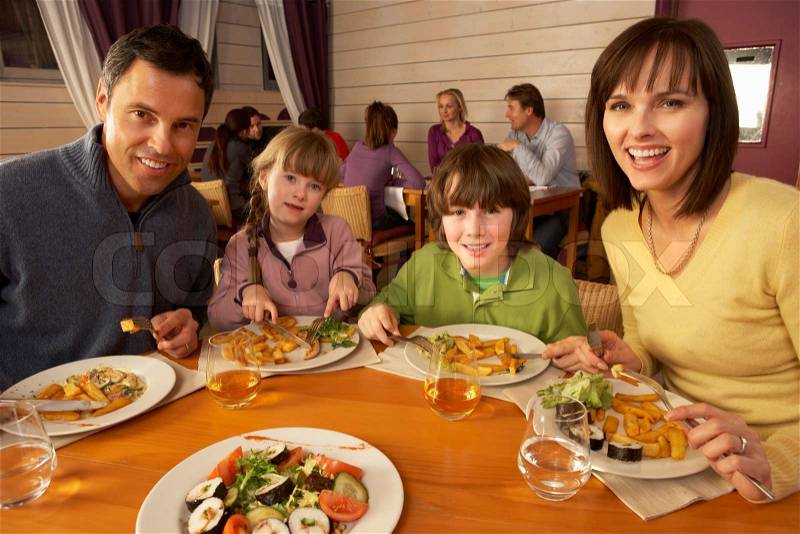 Family Eating Lunch Together In Restaurant, stock photo