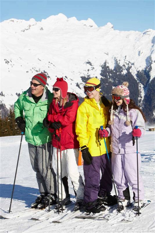 Teenage Family On Ski Holiday In Mountains, stock photo