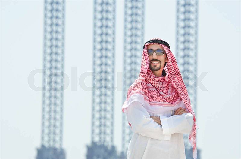 Arab on seaside in traditional clothing, stock photo
