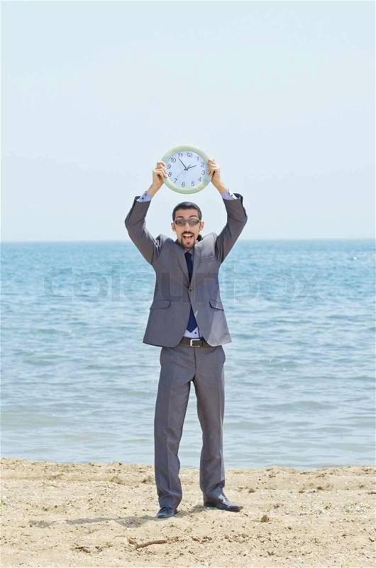 Man with clock on seaside, stock photo