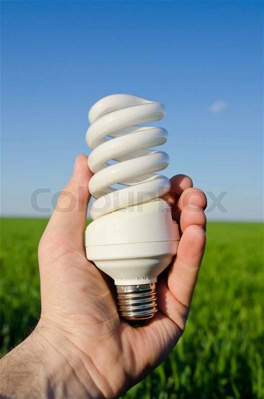 Energy saving lamp in hand, stock photo