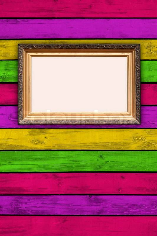 Blank Picture Frame on Multicolored Wooden Wall, stock photo