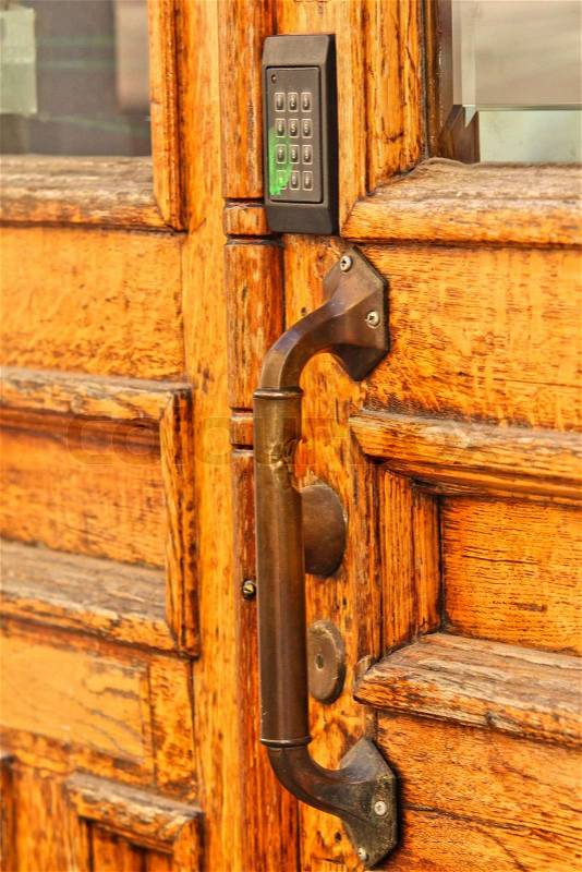 Old wooden door, with modern code opener, stock photo