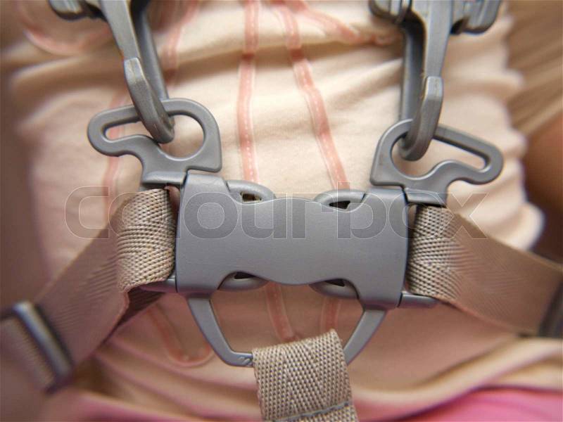 Closeup of a toddler wearing a belt, locked, stock photo