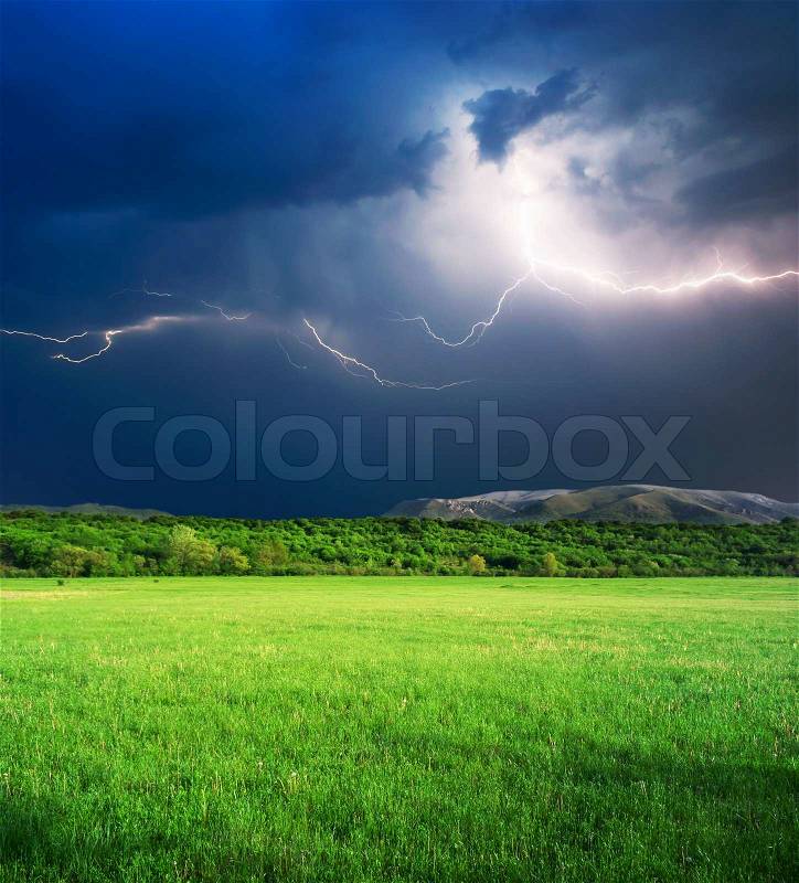 Thunderstorm in green meadow, stock photo