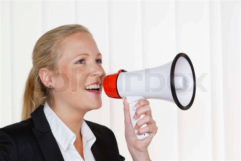 Businesswoman with megaphone, stock photo