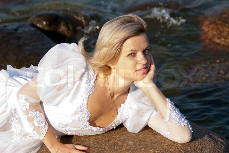 Woman lying on rock, stock photo