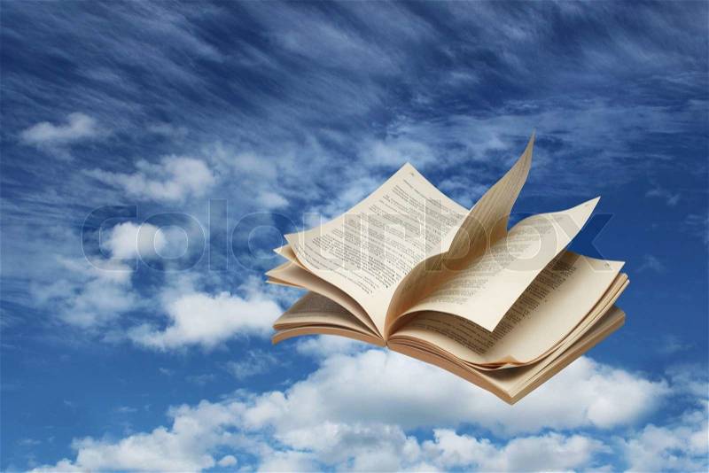 Open book flying on blue sky, stock photo