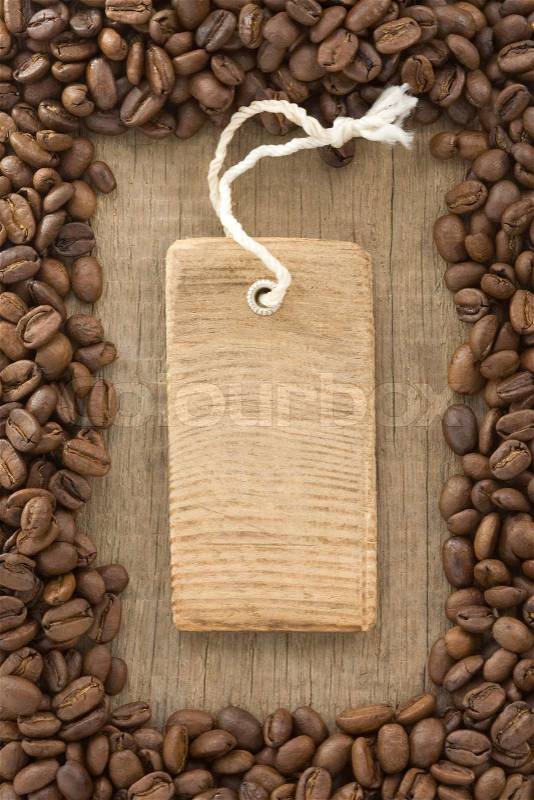 Coffee beans and tag price label on wood, stock photo