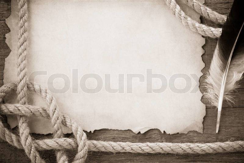 Ropes and feather on old vintage ancient paper, stock photo