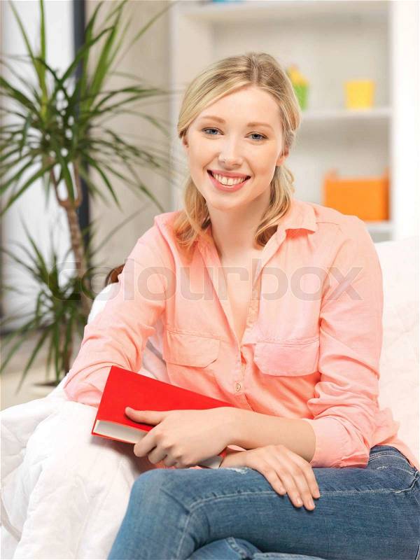 Happy and smiling woman with book, stock photo