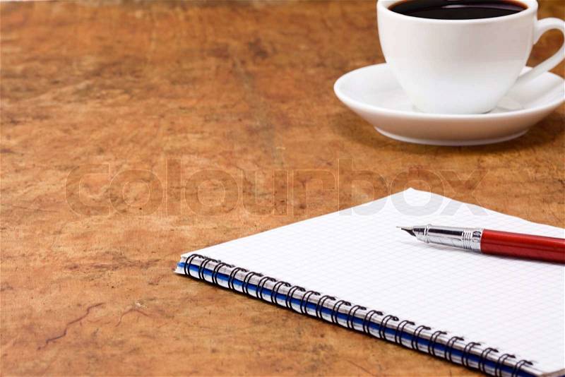 Cup of coffee and binder pad, stock photo
