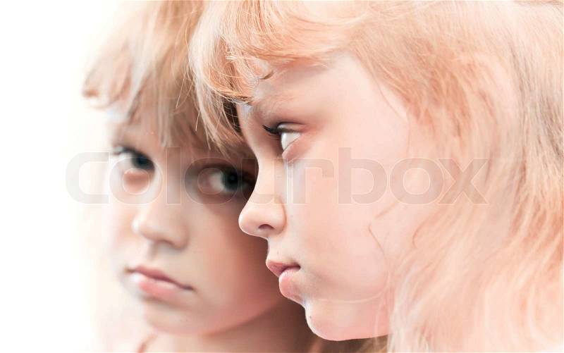 Mirror portrait of a little blond girl, stock photo