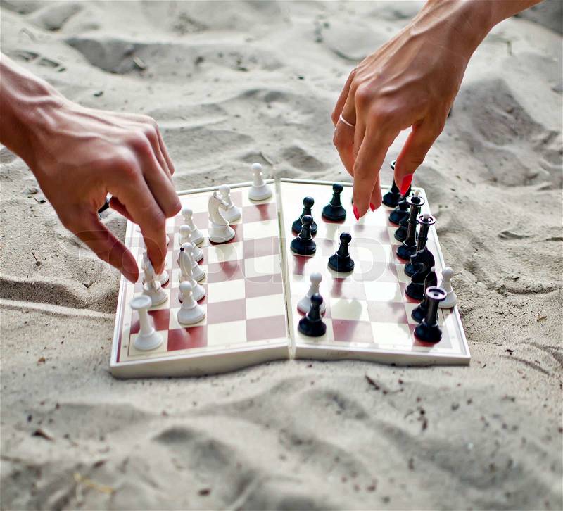 Image of human hands with chess figure making move, stock photo