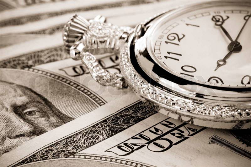 Gold watch on dollar banknotes, stock photo