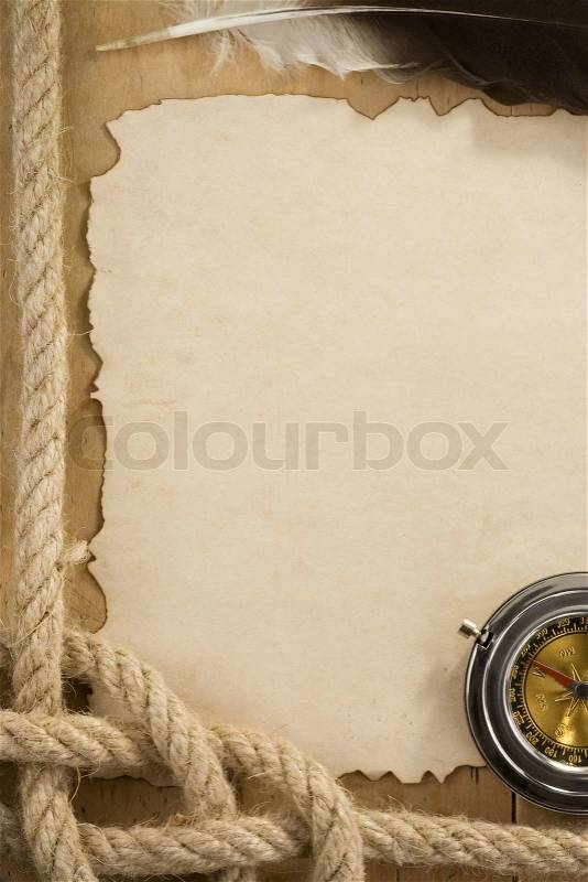 Ropes and compass on old vintage ancient paper background, stock photo