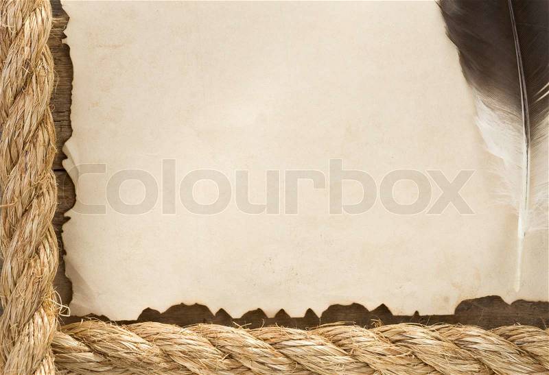 Ship ropes and feather on old vintage ancient paper parchment, stock photo