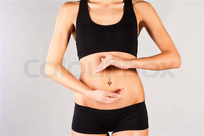 Woman\'s hands on stomach, stock photo
