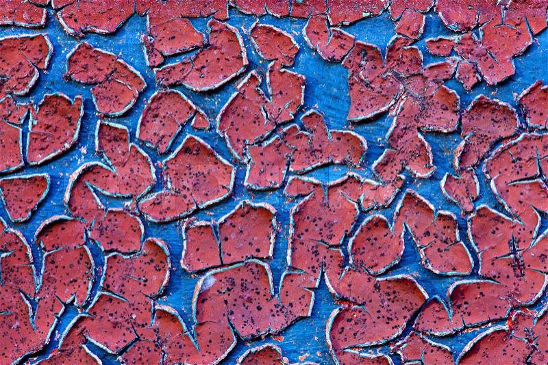 Grunge wall texture background Red paint cracking off the wall with blue paint underneath, stock photo