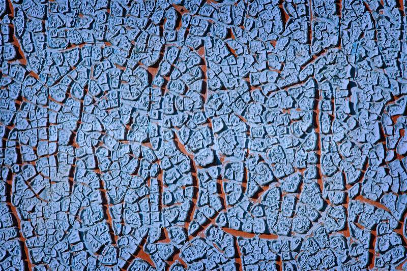 Grunge wall texture background Blue paint cracking off the wall with red paint underneath, stock photo