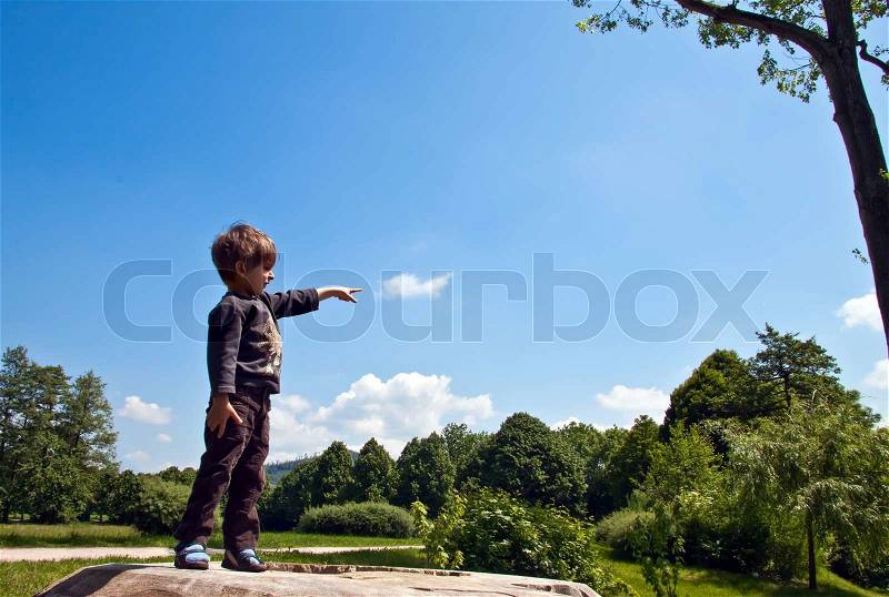 The little boy said, pointing at the sky, stock photo