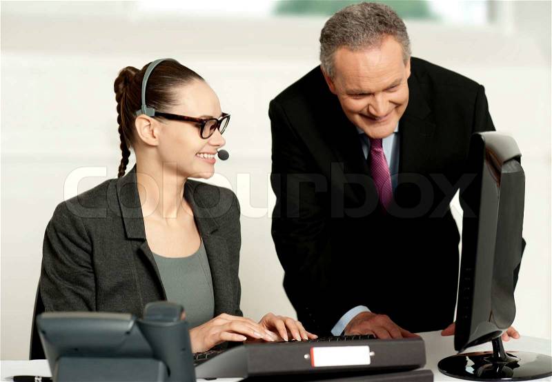 Corporate team working together on computer, stock photo