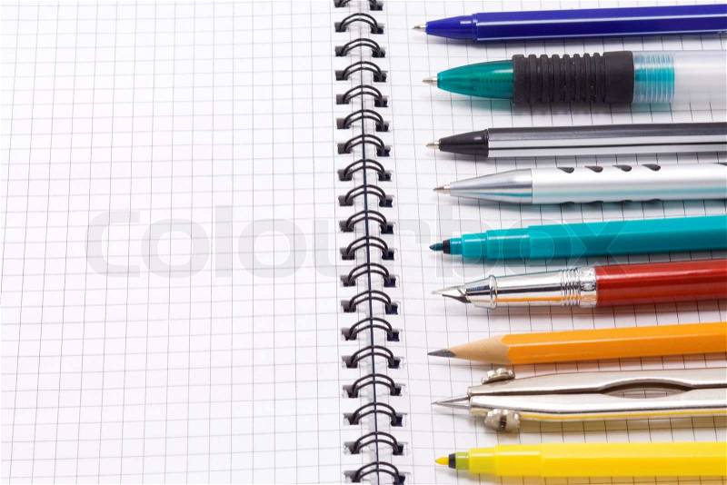 Pen, pencil and felt pen on notebook, stock photo