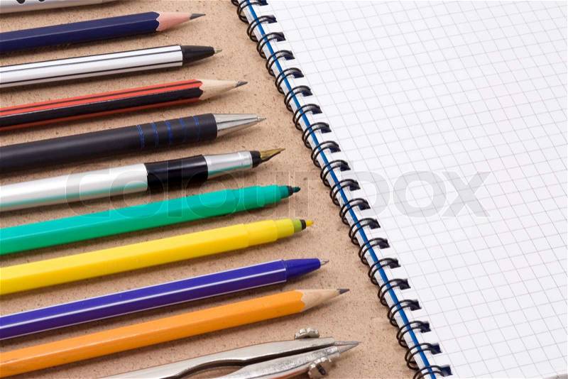 Pen, pencil and felt pen near notebook, stock photo