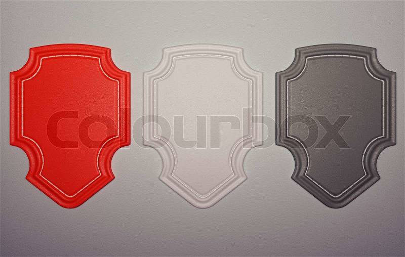 Three labels or tags over grey leather background, stock photo